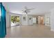 Open-concept living space with terrazzo floors connects to an outdoor patio area at 9 Palm Harbor Dr, Holmes Beach, FL 34217