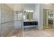 Stylish bathroom with dual sinks, modern shower, and ample counter space at 9 Palm Harbor Dr, Holmes Beach, FL 34217