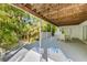Outdoor patio includes lounge seating and backyard access surrounded by lush greenery at 9 Palm Harbor Dr, Holmes Beach, FL 34217