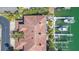 Stunning aerial view shows a waterfront home, boat dock with lifts, and lush greenery at 903 Pinellas Bayway S # 102, St Petersburg, FL 33715