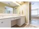 Bathroom featuring double sinks, a vanity, and a glass shower at 903 Pinellas Bayway S # 102, St Petersburg, FL 33715