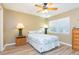Comfortable bedroom with a queen bed, ceiling fan and a wooden floor at 903 Pinellas Bayway S # 102, St Petersburg, FL 33715