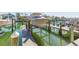 Boat dock showing a boat on a lift system, waterfront homes, and blue skies at 903 Pinellas Bayway S # 102, St Petersburg, FL 33715