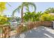 Decking overlooking a tranquil canal with a boat and lush greenery at 903 Pinellas Bayway S # 102, St Petersburg, FL 33715