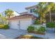 Charming two-story home features a two-car garage, red tile roof, lush landscaping, and a well-maintained exterior at 903 Pinellas Bayway S # 102, St Petersburg, FL 33715
