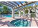 Community hot tub surrounded by an attractive pool and lounging area at 903 Pinellas Bayway S # 102, St Petersburg, FL 33715