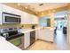 Bright kitchen with stainless steel appliances, track lighting, and easy access to the living area at 903 Pinellas Bayway S # 102, St Petersburg, FL 33715