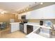 Well-equipped kitchen with white cabinets, stainless steel appliances, and ample counter space at 903 Pinellas Bayway S # 102, St Petersburg, FL 33715