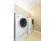Laundry room featuring a side-by-side washer and dryer with overhead storage cabinets at 903 Pinellas Bayway S # 102, St Petersburg, FL 33715