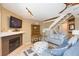 Inviting living room featuring a fireplace, cozy seating, and a staircase, creating a warm atmosphere at 903 Pinellas Bayway S # 102, St Petersburg, FL 33715