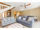 Comfortable living room with sofas, staircase, and seamless flow into dining and kitchen areas at 903 Pinellas Bayway S # 102, St Petersburg, FL 33715