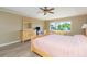 Large main bedroom featuring wood-look floors and large windows with a green view at 903 Pinellas Bayway S # 102, St Petersburg, FL 33715