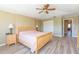 Large main bedroom featuring wood-look floors, a ceiling fan, and lots of closet space at 903 Pinellas Bayway S # 102, St Petersburg, FL 33715