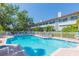 Community pool with lounge chairs and well-maintained landscaping at 903 Pinellas Bayway S # 102, St Petersburg, FL 33715