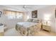 Bright bedroom featuring a comfortable bed, large window, and coastal decor at 915 Beach Rd # 318, Sarasota, FL 34242