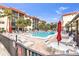 Inviting community pool with lounge chairs and lush tropical landscaping at 915 Beach Rd # 318, Sarasota, FL 34242