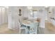 Cozy dining area with a round table and four chairs, adjacent to a passthrough to the kitchen at 915 Beach Rd # 318, Sarasota, FL 34242