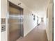 Well-lit hallway leading to the elevator, providing easy access to the building's amenities at 915 Beach Rd # 318, Sarasota, FL 34242