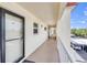 Hallway view of condo featuring secure entry door and access to covered parking at 915 Beach Rd # 318, Sarasota, FL 34242