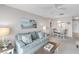 Inviting living room with a comfortable sofa, coastal artwork, and a view of the dining area at 915 Beach Rd # 318, Sarasota, FL 34242