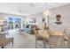 Bright living room with coastal decor, comfortable seating, and a sliding door to a balcony with ocean views at 915 Beach Rd # 318, Sarasota, FL 34242