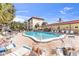 Community pool surrounded by lounge chairs and palm trees for relaxation at 915 Beach Rd # 318, Sarasota, FL 34242