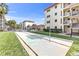 Outdoor shuffleboard court, community pool and building exterior, perfect for recreation at 915 Beach Rd # 318, Sarasota, FL 34242