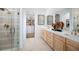 Elegant bathroom features double vanity, glass shower, and access to a walk-in closet at 9998 Key Haven Rd, Seminole, FL 33777