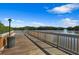Beautiful waterfront dock with wooden railing, perfect for enjoying the view at 9998 Key Haven Rd, Seminole, FL 33777