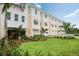 Beautiful townhouse exteriors with manicured lawns and tropical landscaping offering a serene coastal living environment at 9998 Key Haven Rd, Seminole, FL 33777