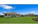 Exterior view of the covered recreation areas set amidst a green landscape with beautiful blue sky and light clouds at 9998 Key Haven Rd, Seminole, FL 33777