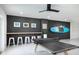 Game room with a ping pong table, bar seating, and decorative surfboard creating a fun and engaging space at 9998 Key Haven Rd, Seminole, FL 33777