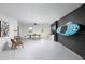 A game room features a ping pong table, bar seating, surfboard, and other recreational amenities at 9998 Key Haven Rd, Seminole, FL 33777