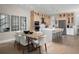 Open-concept kitchen and dining area with stainless steel appliances, island seating, and a dining table for Gathering meals at 9998 Key Haven Rd, Seminole, FL 33777