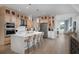 Well-lit kitchen featuring a large island with seating, modern appliances, and light wood cabinetry throughout at 9998 Key Haven Rd, Seminole, FL 33777
