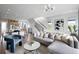 Spacious living room with modern furnishings, open layout, and seamless flow into the kitchen and dining areas at 9998 Key Haven Rd, Seminole, FL 33777