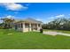 Recreation building on a sunny day featuring a well-manicured lawn and grill, perfect for community gatherings at 9998 Key Haven Rd, Seminole, FL 33777