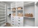 Customizable walk-in closet with multiple shelves and drawer storage for optimal organization at 9998 Key Haven Rd, Seminole, FL 33777