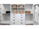 A custom walk-in closet provides ample storage with built-in shelving and drawers at 9998 Key Haven Rd, Seminole, FL 33777