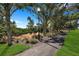 Scenic community walking path lined with trees and lush greenery, providing a tranquil and inviting space for outdoor enjoyment at 9998 Key Haven Rd, Seminole, FL 33777
