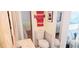 Cozy bathroom with white toilet and a vanity featuring red towels and a palm tree picture at 10315 Cortez W Rd # 71-4, Bradenton, FL 34210