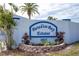Sign entrance to Paradise Bay Estates with lush landscaping and blue accents at 10315 Cortez W Rd # 71-4, Bradenton, FL 34210