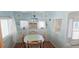 Charming dining area with a table surrounded by four wooden chairs and large windows at 10315 Cortez W Rd # 71-4, Bradenton, FL 34210