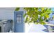 Home exterior with white siding, blue door, and a sun-soaked patio at 10315 Cortez W Rd # 71-4, Bradenton, FL 34210