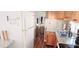 Functional kitchen with wood cabinets, granite counters, and white appliances and hardwood floors at 10315 Cortez W Rd # 71-4, Bradenton, FL 34210