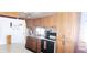 Functional kitchen with wood cabinets, granite counters, and white appliances at 10315 Cortez W Rd # 71-4, Bradenton, FL 34210