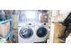 Functional laundry area with modern washer and dryer units surrounded by shelves at 10315 Cortez W Rd # 71-4, Bradenton, FL 34210