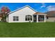 Spacious backyard showcasing the home's screened-in porch and modern architecture at 11233 82Nd E St, Parrish, FL 34219