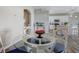 Bright dining area with a glass table, stylish chairs, and an open view to the modern kitchen at 11233 82Nd E St, Parrish, FL 34219
