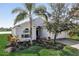 Charming single-story home with well-maintained landscaping, lush greenery, and a welcoming entrance at 11233 82Nd E St, Parrish, FL 34219